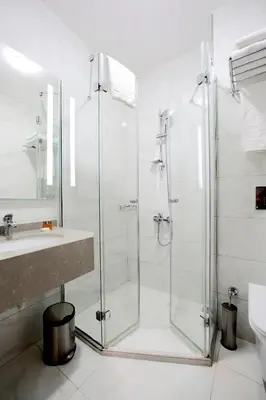 a bathroom with a glass shower and a sink at Hotel Eyfel in Istanbul
