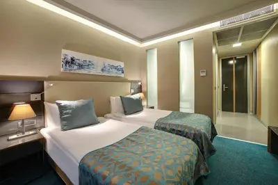 a hotel room with two beds and a window at Divan Corlu in Corlu