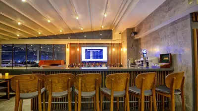 a bar in a restaurant with wooden chairs at Samir Deluxe Hotel in Istanbul