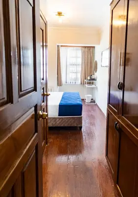 a bedroom with a bed and a window and a door at Cheers Hostel in Istanbul