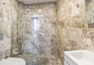 a bathroom with a shower and a toilet and a sink at Cheers Hostel in Istanbul