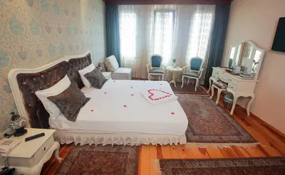 a bedroom with a large bed and a desk at Esans Hotel - Special Category in Istanbul