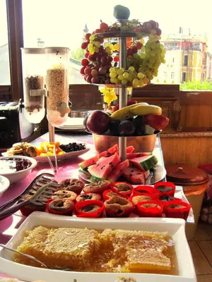 a table with a bunch of fruit and muffins at Esans Hotel - Special Category in Istanbul