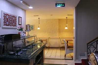 a waiting room with a table and chairs in a room at Hotel Novano in Istanbul