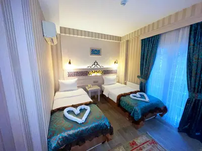 a hotel room with two beds with hearts on them at Hotel Novano in Istanbul