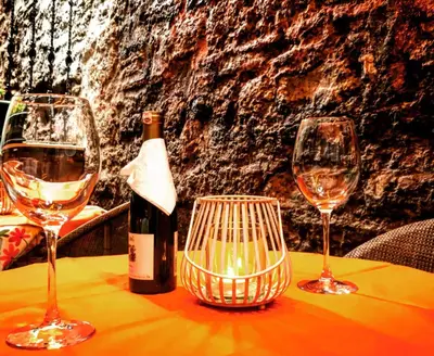 a table with two glasses and a bottle of wine at Hotel Novano in Istanbul