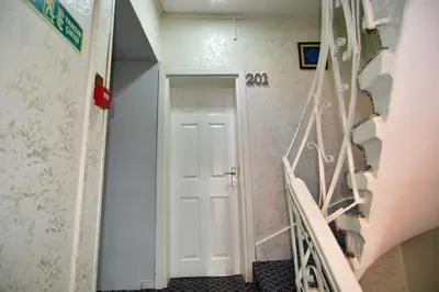 a hallway with a white door and stairs at Hotel Han in Istanbul