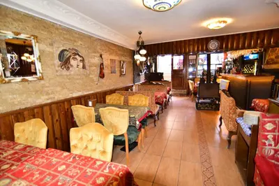 a restaurant with tables and chairs and a bar at Hotel Han in Istanbul
