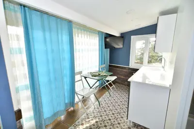 a kitchen with blue curtains and a table at Hotel Han in Istanbul