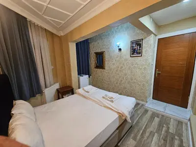 a bedroom with a white bed and a window at Asitane Life Hotel in Istanbul