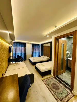 a hotel room with two beds and a table at Sirkeci Quietness Hotel in Istanbul