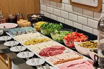 a buffet with many different types of meats and vegetables at Holiday Inn Express - Istanbul - Atakoy Metro by IHG in Istanbul