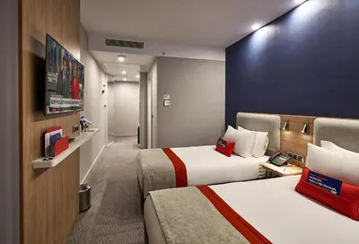 a hotel room with two beds and a tv at Holiday Inn Express - Istanbul - Atakoy Metro by IHG in Istanbul