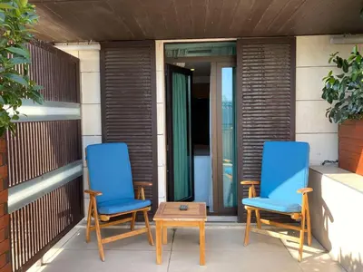 two blue chairs and a table on a porch at DoubleTree By Hilton Istanbul - Old Town in Istanbul