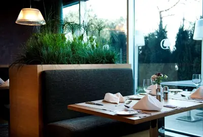 a table in a restaurant with a table set for dinner at DoubleTree By Hilton Istanbul - Moda in Istanbul
