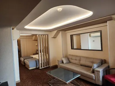 a living room with a couch and a mirror at Nanda Hotel in Istanbul