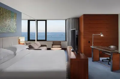 a hotel room with a bed and a desk and a television at Sheraton Istanbul Atakoy Hotel in Istanbul