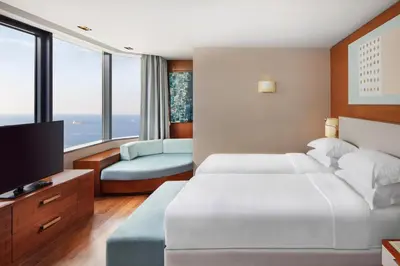 a bedroom with two beds and a flat screen tv at Sheraton Istanbul Atakoy Hotel in Istanbul