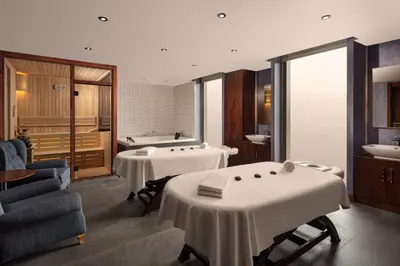 a room with two tables and a bath tub at Sheraton Istanbul Atakoy Hotel in Istanbul