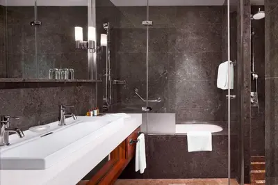 a bathroom with two sinks and a shower at Sheraton Istanbul Atakoy Hotel in Istanbul