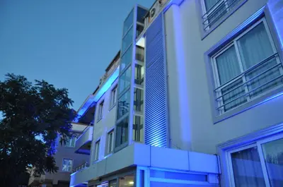 a white building with blue lights on it at dragos island hotel in Istanbul