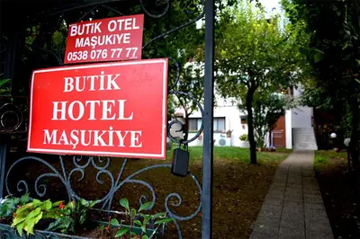 a red sign that reads build hotel hospital masivive at Butik Hotel Maşukiye in Masukiye