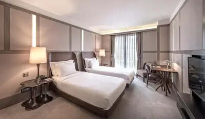 a hotel room with two beds and a television at The Stay Nisantasi in Istanbul