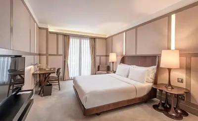 a hotel room with a large bed and a desk at The Stay Nisantasi in Istanbul
