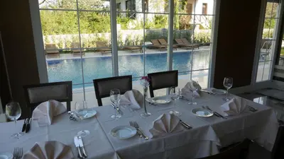 a dining table with white tablecloths and napkins on it at The Escape Hotel in Agva