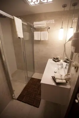 a bathroom with a shower and a sink at The Escape Hotel in Agva
