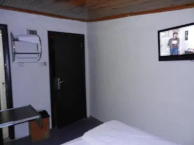 a bedroom with a bed and a tv on the wall at Cagri Hotel in Istanbul