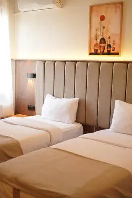 two beds sitting next to each other in a room at Lion City Hotel Bursa in Bursa