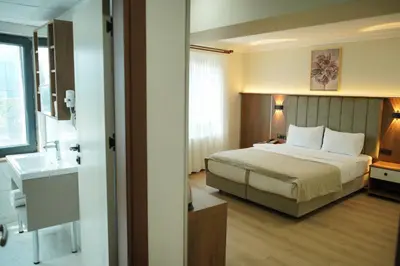 a hotel room with a bed and a sink at Lion City Hotel Bursa in Bursa