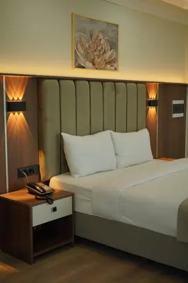 a hotel room with a bed and a table at Lion City Hotel Bursa in Bursa