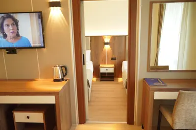 a hotel room with a television on the wall at Lion City Hotel Bursa in Bursa