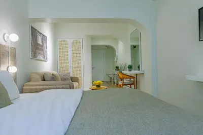 a bedroom with a bed and a living room at The Wilson Galata Hotel in Istanbul