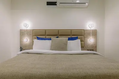 a bedroom with a large bed with two lights on it at The Wilson Galata Hotel in Istanbul