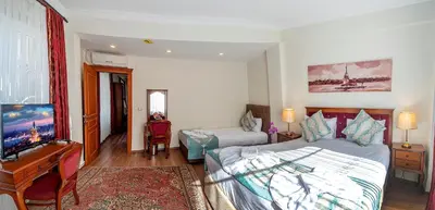 a bedroom with a bed and a desk and a piano at Sultan House in Istanbul