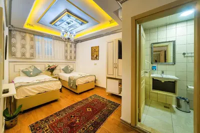 a bedroom with two beds and a bathroom with a shower at Sultan House in Istanbul