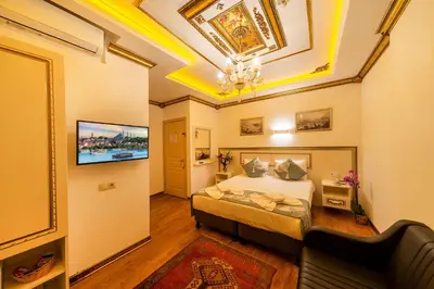 a bedroom with a bed and a flat screen tv at Sultan House in Istanbul