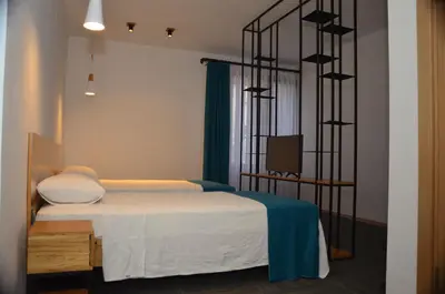 a bedroom with a bed and a television in it at Pera Hotel Lüleburgaz in Lüleburgaz