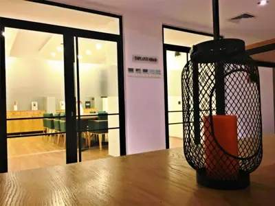 a vase sitting on top of a wooden table at Pera Hotel Lüleburgaz in Lüleburgaz