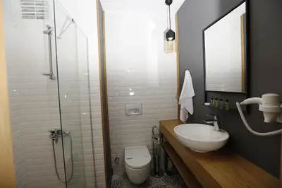 a bathroom with a sink and a toilet and a shower at Pera Hotel Lüleburgaz in Lüleburgaz