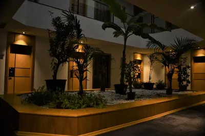 a lobby with potted plants in a building at Pera Hotel Lüleburgaz in Lüleburgaz