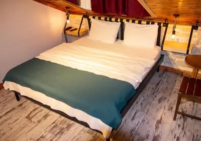 a large bed in a room with a wooden floor at Hot Budget Ortakoy in Istanbul