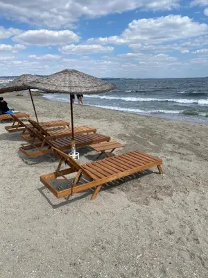 a group of lounge chairs and an umbrella on the beach at Odrys Beach Hotel & Resort in Tekirdag
