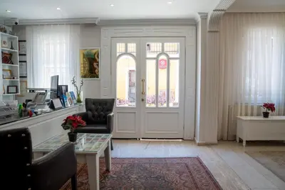 a living room with a door and a chair at Sultanahmet Cesme Hotel in Istanbul