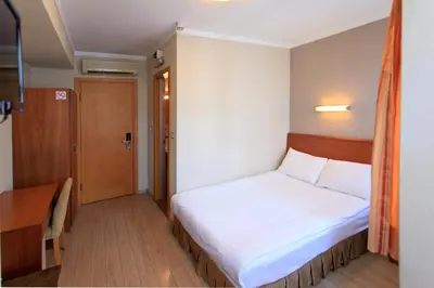 a bedroom with a white bed and a door at Hotel Inter Istanbul in Istanbul