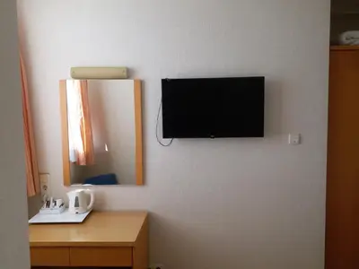 a bathroom with a mirror and a tv on a wall at Hotel Inter Istanbul in Istanbul