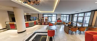 a lobby with a bar and chairs in a building at Innpera Hotel in Istanbul